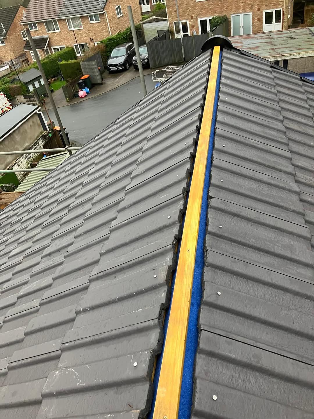 Ridge batten mechanically fixed on a new grey tiled roof