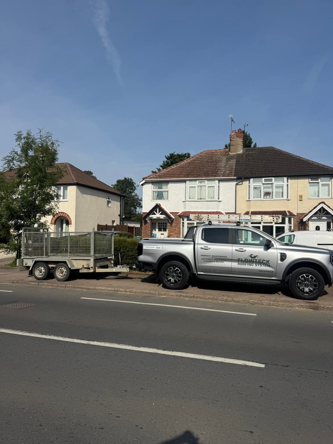 Signwritten Flowteck pickup parked at a customer's property