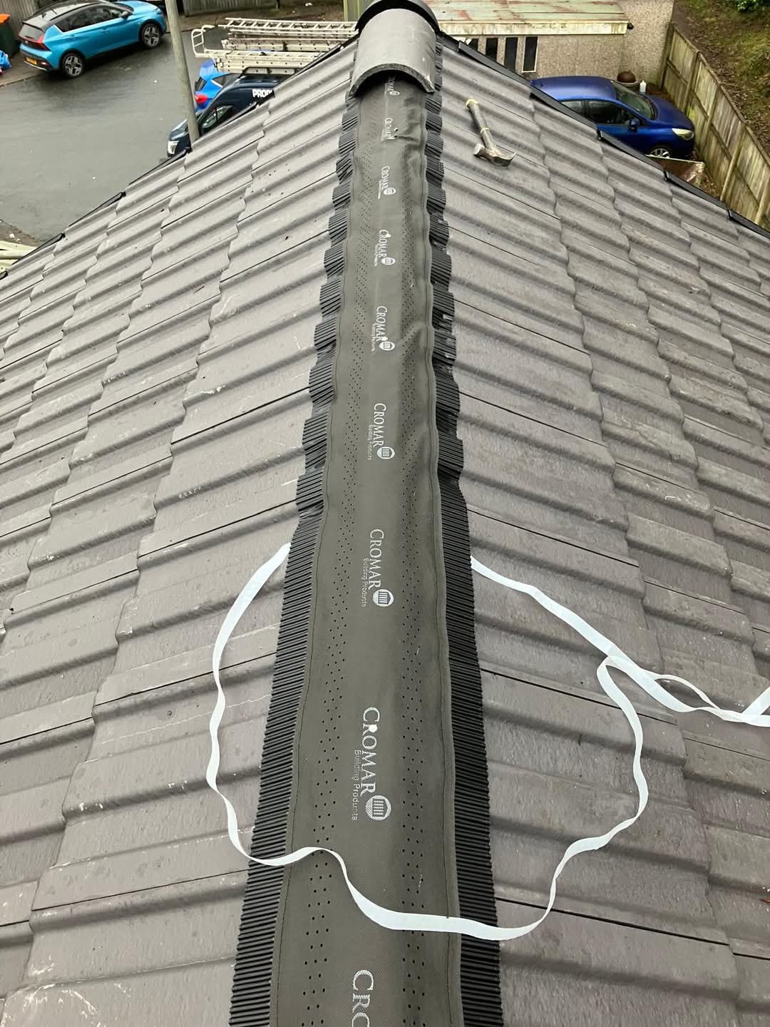 Ventilated dry ridge roll bedded along new grey tiles